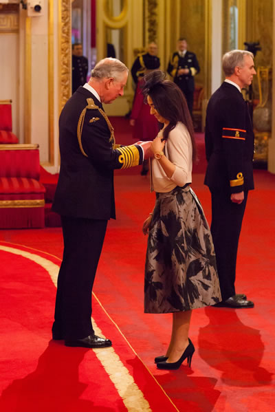 Sajda Mughal receiving OBE from Prince Charles